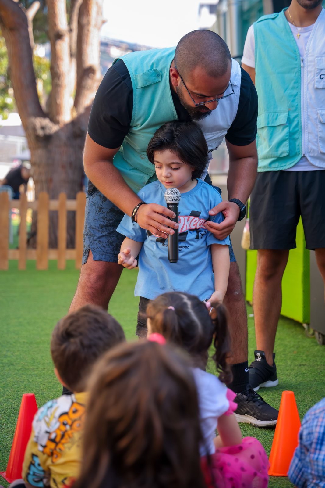 A child speaking into a microphone during a Recreo group activity