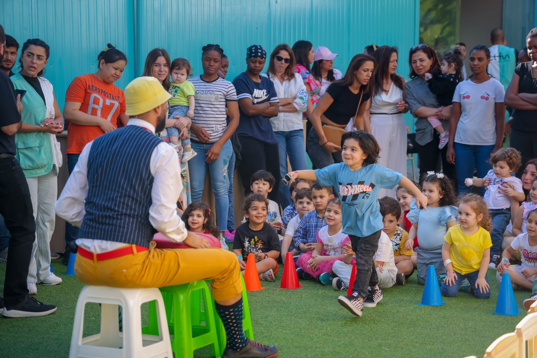 Children watching and participating in an outdoor Recreo show