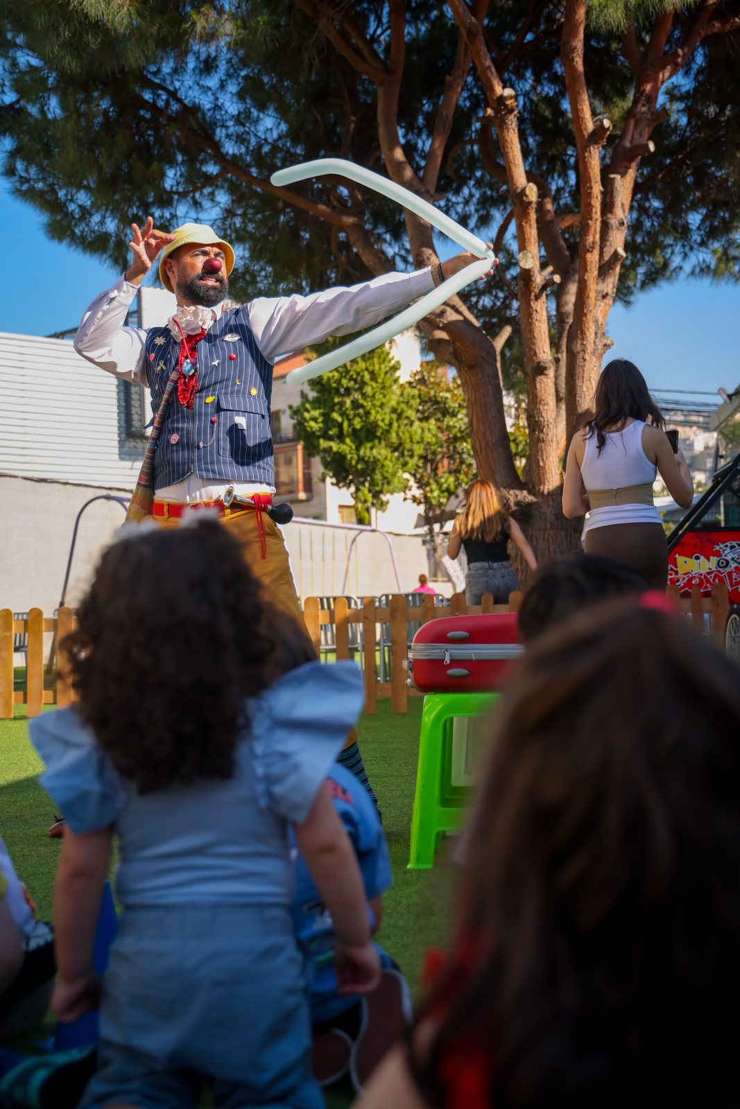 A Recreo performer leading a balloon activity during a weekend show